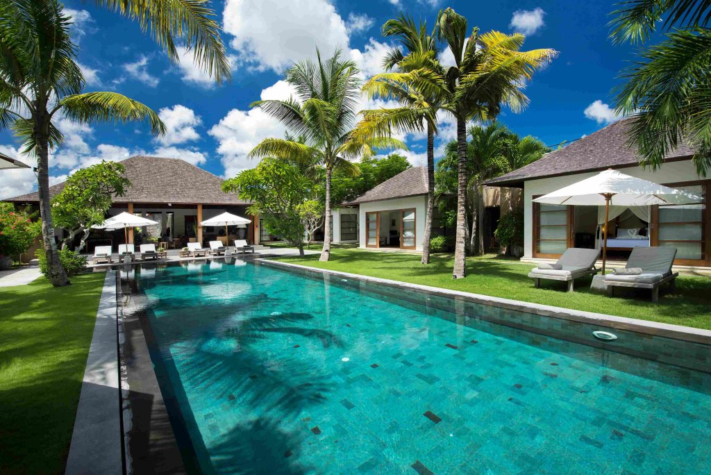 Villa Tiga Puluh, a modern tropical villa featuring a private pool, open-air living spaces, lush gardens, and Balinese-inspired architecture for a relaxing stay.