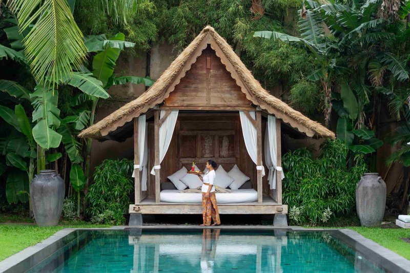 Villa Tiga Puluh, a modern tropical villa featuring a private pool, open-air living spaces, lush gardens, and Balinese-inspired architecture for a relaxing stay.