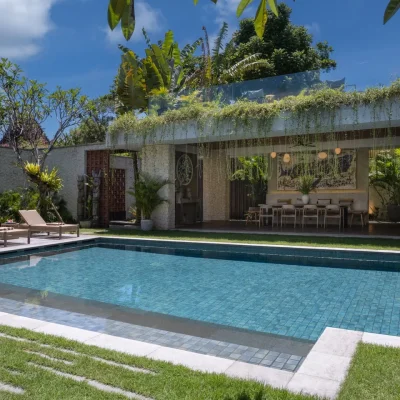 Rooftop deck of Villa Pantai Indah with sun loungers and sunset views in Canggu Bali