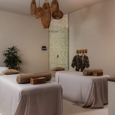 INKA Spa featuring a serene wellness environment with tropical décor, open-air treatment areas, and a relaxing ambiance for spa therapies.