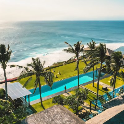 The Istana Villa, a luxurious tropical villa featuring a private infinity pool, spacious open-air living areas, lush gardens, and elegant Balinese design.