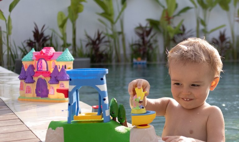 kids at the villa pool with his toys