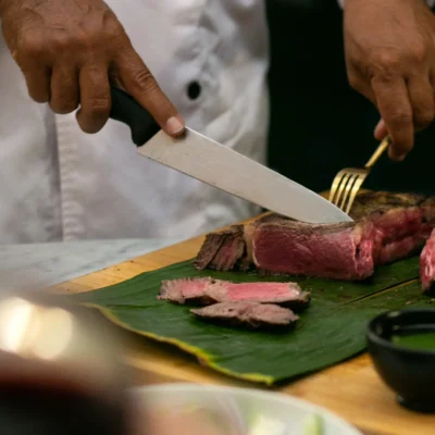 12. Dining Room – chef serving wagyu steak_23_11zon Villa Kasianda House - Villa Gallery