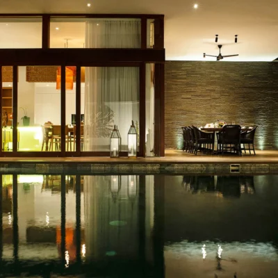 Pool and dining area at night Villa Indrani - Villa Gallery