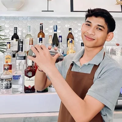 Private cocktail bar service in a Bali villa, featuring a professional bartender preparing drinks by the poolside with tropical surroundings.