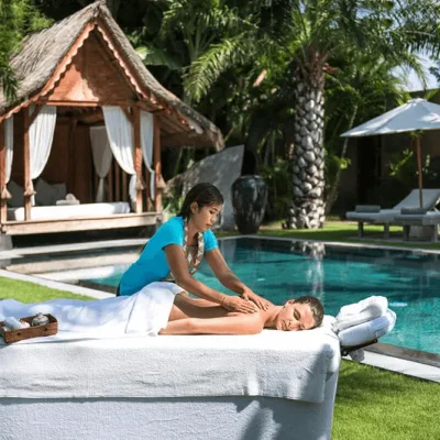 Relaxing in-villa spa session in Bali, featuring a massage setup in a private villa surrounded by tropical greenery for a serene wellness experience.