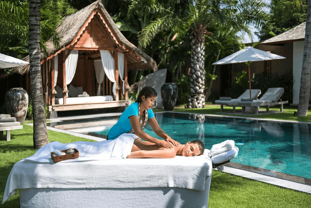 Relaxing in-villa spa session in Bali, featuring a massage setup in a private villa surrounded by tropical greenery for a serene wellness experience.