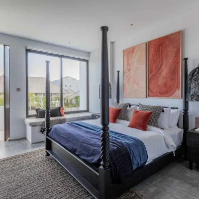 MandalaOasis_Bali_14_Bedroom2_11zon A luxurious tropical villa named Mandala Oasis Villa, featuring an infinity pool surrounded by palm trees, lush gardens, and modern open-air architecture under a bright blue sky.