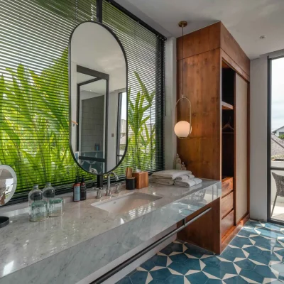Mandala Oasis Villa A luxurious tropical villa named Mandala Oasis Villa, featuring an infinity pool surrounded by palm trees, lush gardens, and modern open-air architecture under a bright blue sky.