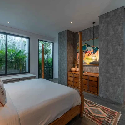 Mandala Oasis Villa A luxurious tropical villa named Mandala Oasis Villa, featuring an infinity pool surrounded by palm trees, lush gardens, and modern open-air architecture under a bright blue sky.
